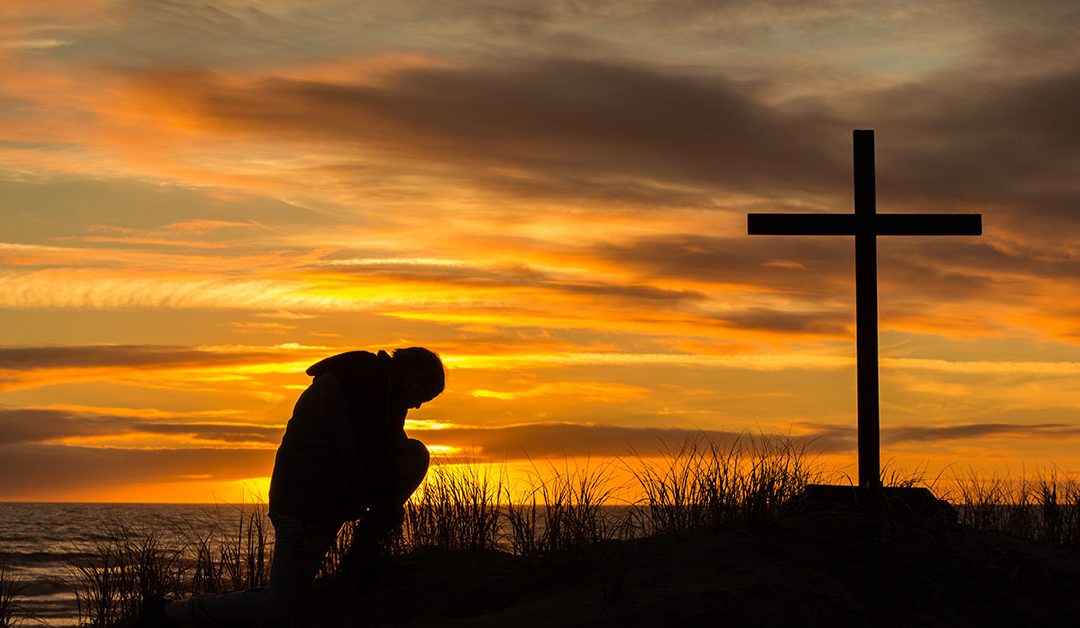 Man bowing at the cross
